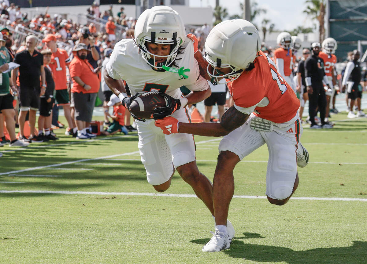 Miami Hurricanes wide receiver Daylyn Upshaw (7) catches a touchdown pass as defensive back Brody Jennings (15) defends as during UM’s spring football game at Cobb Stadium on the University of Miami campus in Coral Gables, Florida, on Saturday, April 18, 2026.
